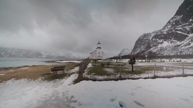 View of Gims&oslash;y Church and snowy mountains Norway.