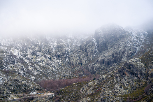Aerial view of Covao d Ametade glacial valley with rugged rocky cliffs and mist covered mountain peaks in Loriga Guarda District Portugal. Aerial view of Covao d Ametade glacial valley with rugged rocky cliffs and mist covered mountain peaks in Loriga Guarda District Portugal.
