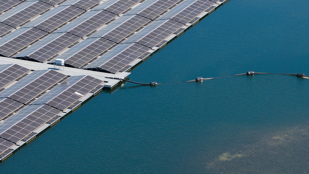 Aerial view of rows of floating solar panels installed on a calm blue lake surface with connecting cables Zwolle Overijssel Netherlands. Aerial view of rows of floating solar panels installed on a calm blue lake surface with connecting cables Zwolle Overijssel Netherlands.
