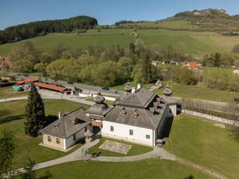 Aerial view of Kastiel Kubinyi manor house with its unique shingle roofs and onion domes set against lush green hills and a clear blue sky in Vysny Kubin Zilinsky kraj Slovakia. Aerial view of Kastiel Kubinyi manor house with its unique shingle roofs and onion domes set against lush green hills and a clear blue sky in Vysny Kubin Zilinsky kraj Slovakia.