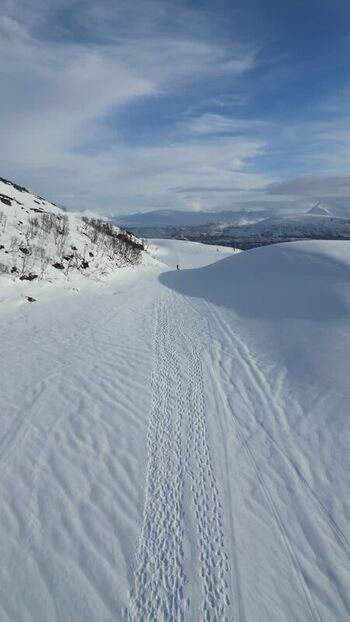 Aerial view of snowy mountain slopes on Kvaloya island Norway.