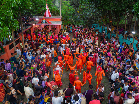 Munshiganj Bangladesh 13 April 2026 Aerial view of a vibrant festival energetic orange clad performers amidst a dense crowd near a colorful temple.