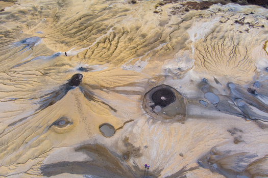 Aerial view of the Mud Volcanoes of Paclele Mari showing unique geological formations grey mud craters and arid landscape in Paclele Buzau County Romania.