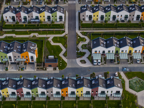 Aerial view of Residential Park Lozen featuring rows of colorful modern townhouses with manicured green lawns and paved walkways in Sofia Sofia City Province Bulgaria. Aerial view of Residential Park Lozen featuring rows of colorful modern townhouses with manicured green lawns and paved walkways in Sofia Sofia City Province Bulgaria.