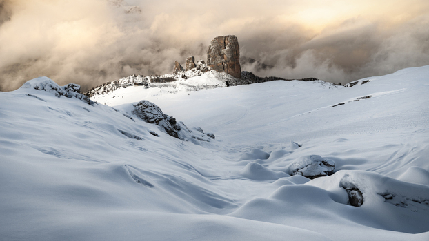 View of the Cinque Torri rock formations surrounded by thick clouds and deep snow in the Dolomites Trentino Alto Adige Italy. View of the Cinque Torri rock formations surrounded by thick clouds and deep snow in the Dolomites Trentino Alto Adige Italy.