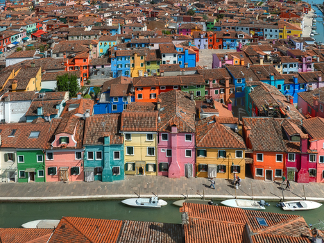 Aerial view of vibrant houses painted in rainbow hues line the canals a dazzling display of color under the Italian sun Burano Venice Veneto Italy. Aerial view of vibrant houses painted in rainbow hues line the canals a dazzling display of color under the Italian sun Burano Venice Veneto Italy.
