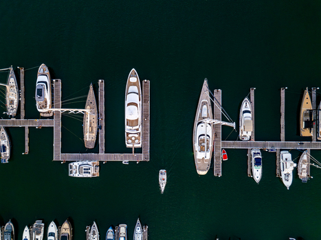 Aerial view of Marina de Cascais with various yachts and sailboats moored at wooden docks in the calm blue water of the Atlantic Ocean in Cascais Lisboa Portugal. Aerial view of Marina de Cascais with various yachts and sailboats moored at wooden docks in the calm blue water of the Atlantic Ocean in Cascais Lisboa Portugal.
