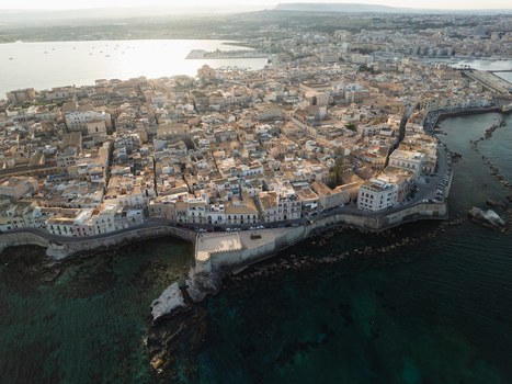 Aerial view of the Island of Ortigia with its historic stone buildings ancient fortifications and the surrounding turquoise Mediterranean Sea Syracuse Sicily Italy. Aerial view of the Island of Ortigia with its historic stone buildings ancient fortifications and the surrounding turquoise Mediterranean Sea Syracuse Sicily Italy.