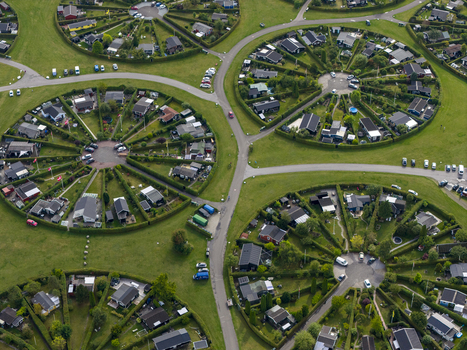 Aerial view of Haveforeningen Harekaer circular allotment gardens with small houses and green hedges in Brondby Denmark. Aerial view of Haveforeningen Harekaer circular allotment gardens with small houses and green hedges in Brondby Denmark.