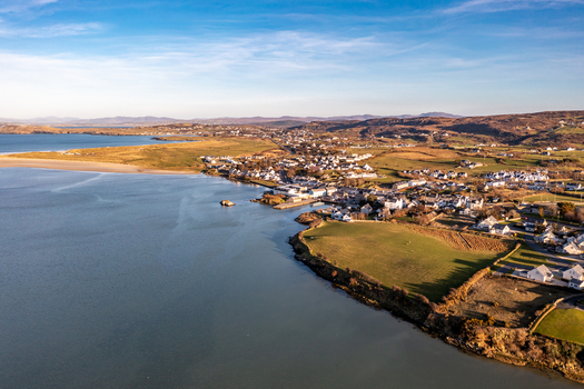 Aerial view of Dunfanaghy village along the coastline of County Donegal with sandy beaches green fields and rolling hills in Dunfanaghy County Donegal Ireland. Aerial view of Dunfanaghy village along the coastline of County Donegal with sandy beaches green fields and rolling hills in Dunfanaghy County Donegal Ireland.
