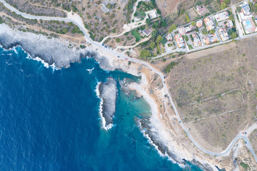 Aerial view of Riserva Naturale Orientata dello Zingaro with its rocky coastline turquoise sea and coastal road winding through the Mediterranean landscape in San Vito Lo Capo Sicilia Italy. Aerial view of Riserva Naturale Orientata dello Zingaro with its rocky coastline turquoise sea and coastal road winding through the Mediterranean landscape in San Vito Lo Capo Sicilia Italy.