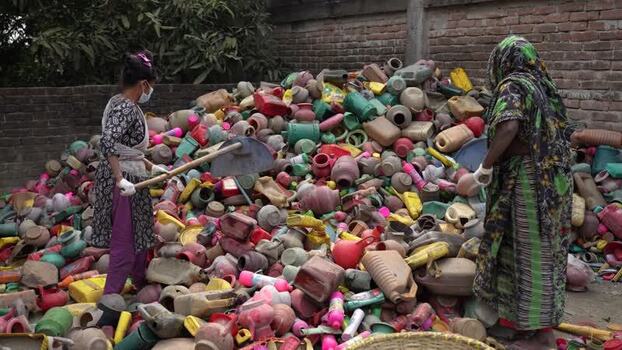 View of workers sorting colorful plastic waste in Jashore Bangladesh. View of workers sorting colorful plastic waste in Jashore Bangladesh.