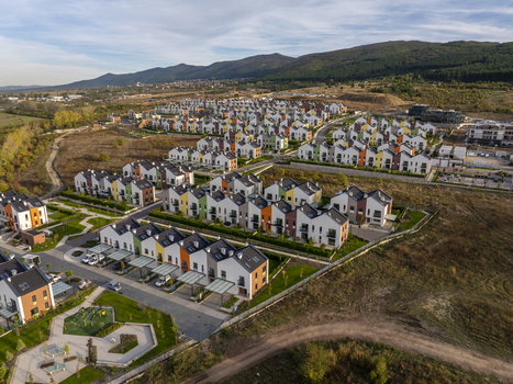 Aerial view of the modern Residential Park Lozen complex with colorful houses green lawns and paved streets set against a mountainous landscape in Sofia Sofia City Province Bulgaria. Aerial view of the modern Residential Park Lozen complex with colorful houses green lawns and paved streets set against a mountainous landscape in Sofia Sofia City Province Bulgaria.