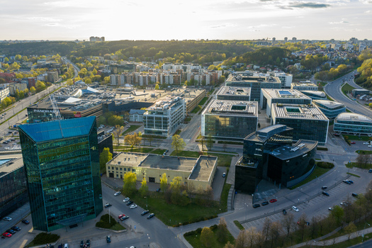 Vilnius County Lithuania 01 May 2026 Aerial view of modern office buildings and the Panorama shopping center in the business district with green hills in the background. Vilnius County Lithuania 01 May 2026 Aerial view of modern office buildings and the Panorama shopping center in the business district with green hills in the background.