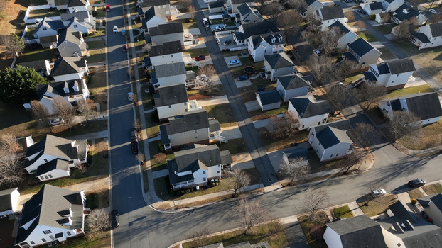 Aerial view of a quiet suburban neighborhood with detached houses paved streets and residential driveways in Lynchburg Virginia United States.