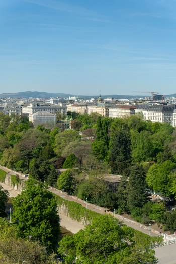 Aerial view of the lush greenery of Stadtpark and the historic city skyline under a clear blue sky in Vienna Vienna Austria. Aerial view of the lush greenery of Stadtpark and the historic city skyline under a clear blue sky in Vienna Vienna Austria.