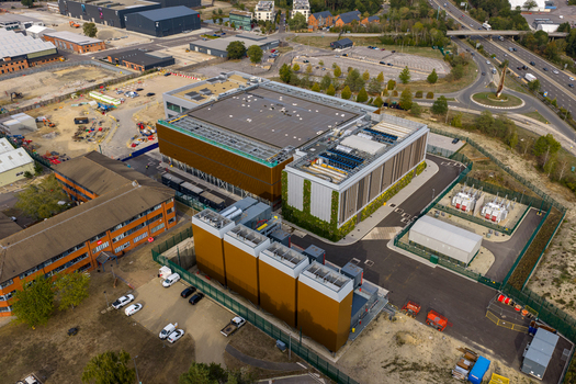 Aerial view of Ark Data Centres Longcross Park featuring modern industrial buildings cooling units and surrounding infrastructure in Chertsey England United Kingdom. Aerial view of Ark Data Centres Longcross Park featuring modern industrial buildings cooling units and surrounding infrastructure in Chertsey England United Kingdom.