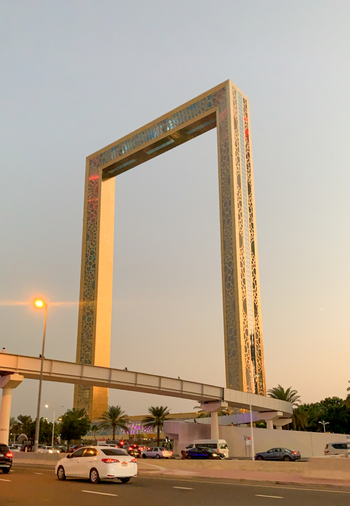 View of the iconic Dubai Frame standing tall against the clear sky with a pedestrian bridge and traffic on the road below Dubai Dubai United Arab Emirates. View of the iconic Dubai Frame standing tall against the clear sky with a pedestrian bridge and traffic on the road below Dubai Dubai United Arab Emirates.