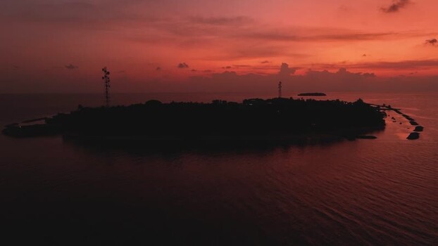 Aerial view of Kendhoo island silhouette at sunset Maldives. Aerial view of Kendhoo island silhouette at sunset Maldives.