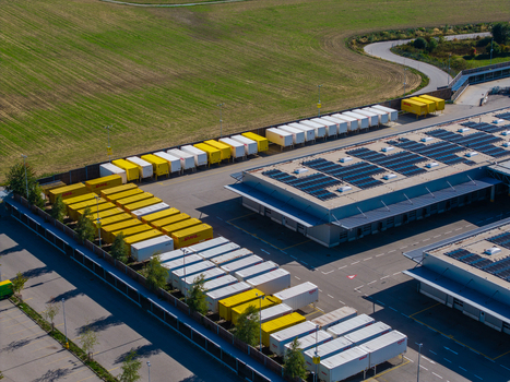 Aerial view of DHL Logistikzentrum Allhaming with rows of yellow and white shipping containers warehouse buildings with solar panels and parking in Allhaming Oberosterreich Austria. Aerial view of DHL Logistikzentrum Allhaming with rows of yellow and white shipping containers warehouse buildings with solar panels and parking in Allhaming Oberosterreich Austria.