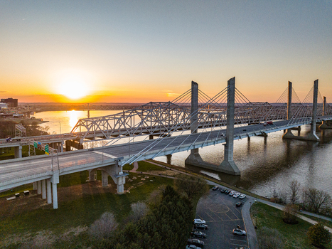 Aerial view of the Abraham Lincoln Bridge and John F. Kennedy Memorial Bridge spanning the Ohio River during a golden sunset Louisville Kentucky United States. Aerial view of the Abraham Lincoln Bridge and John F. Kennedy Memorial Bridge spanning the Ohio River during a golden sunset Louisville Kentucky United States.