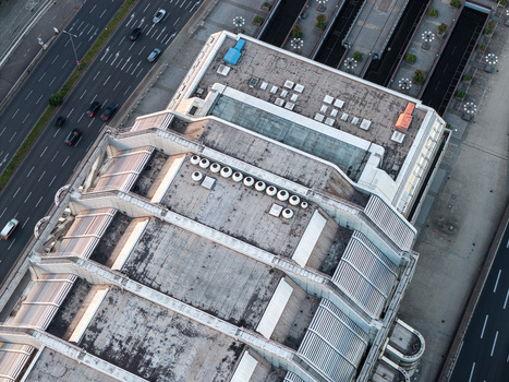 Aerial view of the ICC Berlin a prominent example of Brutalist architecture with its metallic facade and complex roof structure next to a highway in Berlin Berlin Germany. Aerial view of the ICC Berlin a prominent example of Brutalist architecture with its metallic facade and complex roof structure next to a highway in Berlin Berlin Germany.