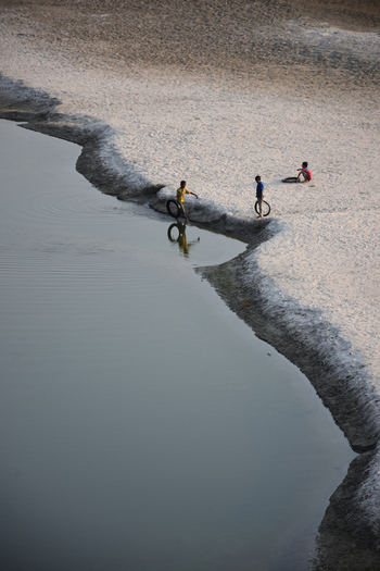 Kushtia District Khulna Division Bangladesh 10 March 2020 View of children playing with tires on the sandy riverbank. Kushtia District Khulna Division Bangladesh 10 March 2020 View of children playing with tires on the sandy riverbank.