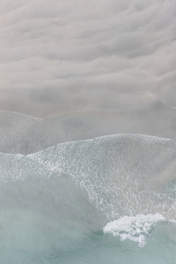Aerial view of Lofoten beach with gentle waves washing over white sand in Leknes Nordland Norway. Aerial view of Lofoten beach with gentle waves washing over white sand in Leknes Nordland Norway.