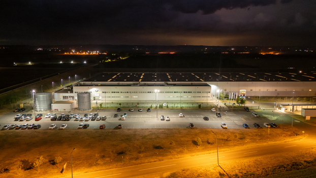 Aerial view of a large industrial facility and parking lot illuminated at night Sremska Mitrovica Vojvodina Serbia. Aerial view of a large industrial facility and parking lot illuminated at night Sremska Mitrovica Vojvodina Serbia.