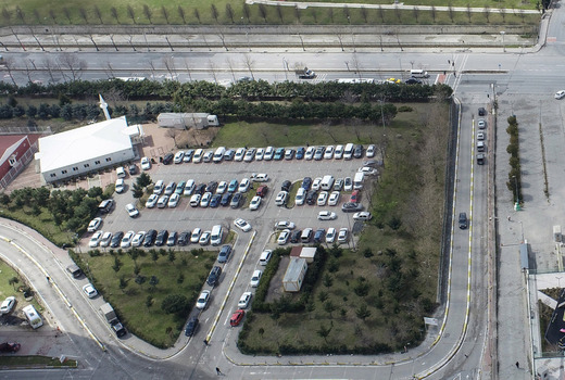 Aerial view of a parking lot with rows of vehicles and a small white building surrounded by trees Sariyer Istanbul Turkiye. Aerial view of a parking lot with rows of vehicles and a small white building surrounded by trees Sariyer Istanbul Turkiye.
