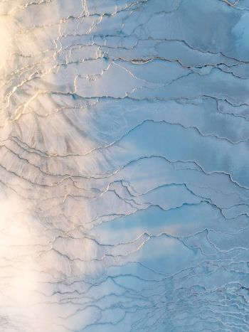 Aerial view of Reykjanes geothermal landscape with intricate mineral deposits and blue water pools in Grindavikurbaer Iceland. Aerial view of Reykjanes geothermal landscape with intricate mineral deposits and blue water pools in Grindavikurbaer Iceland.