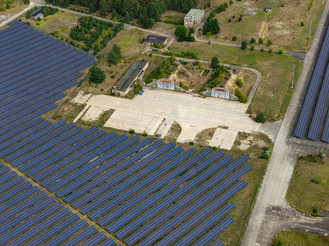 Aerial view of the solar field at the former military airfield in Preschen with rows of solar panels historic hangars and old runway remnants in Neisse Malxetal Brandenburg Germany. Aerial view of the solar field at the former military airfield in Preschen with rows of solar panels historic hangars and old runway remnants in Neisse Malxetal Brandenburg Germany.