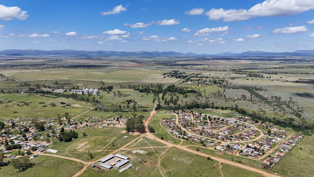 Aerial view of the rural settlement of Alma with small houses dirt roads and grain silos set against a vast landscape Waterberg District Municipality Limpopo South Africa. Aerial view of the rural settlement of Alma with small houses dirt roads and grain silos set against a vast landscape Waterberg District Municipality Limpopo South Africa.