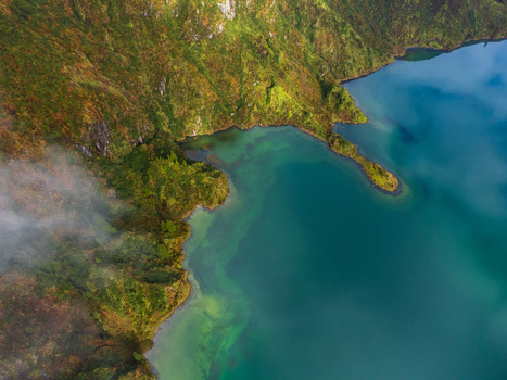 Aerial view of Lagoa do Fogo crater lake with lush green volcanic slopes and turquoise water in Agua de Alto Azores Portugal. Aerial view of Lagoa do Fogo crater lake with lush green volcanic slopes and turquoise water in Agua de Alto Azores Portugal.