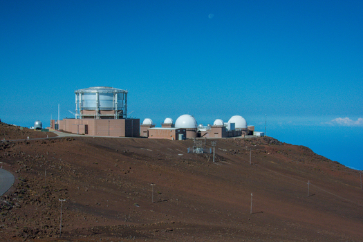 View of the Haleakala Observatory domes situated on the volcanic terrain of Maui County Hawaii United States.
