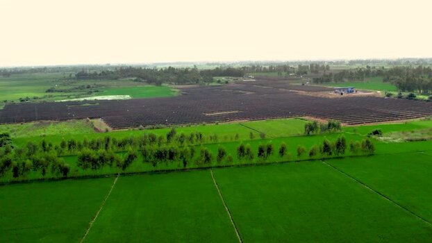 Aerial view of solar farm in rural landscape India.
