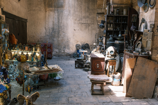 View of Khan el Khalili market stall with traditional lamps antiques and metalwork inside a historic stone building in El Gamaleya Cairo Governorate Egypt. View of Khan el Khalili market stall with traditional lamps antiques and metalwork inside a historic stone building in El Gamaleya Cairo Governorate Egypt.