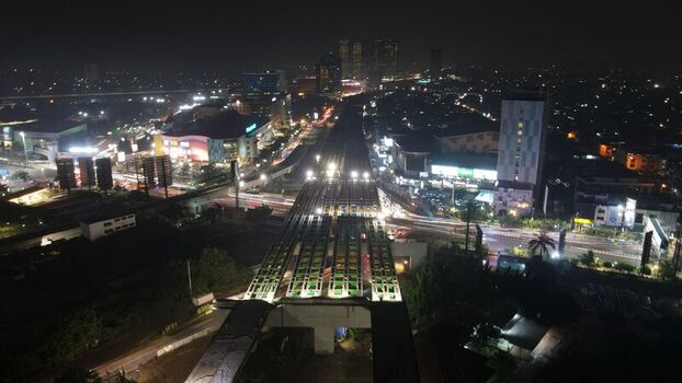 Aerial view of the illuminated elevated highway construction and urban landscape at night in Bekasi Barat West Java Indonesia. Aerial view of the illuminated elevated highway construction and urban landscape at night in Bekasi Barat West Java Indonesia.