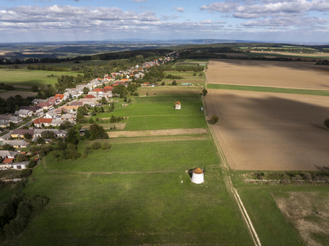 Aerial view of the historic Tesi Windmills and Smithy surrounded by green fields and the village of Tes Hungary. Aerial view of the historic Tesi Windmills and Smithy surrounded by green fields and the village of Tes Hungary.