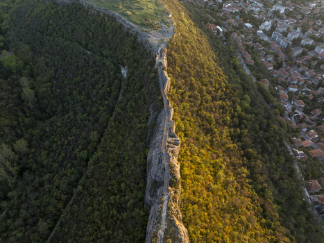 Aerial view of the historic Ovech Fortress situated on a narrow rocky plateau surrounded by lush forests and the town of Provadia Varna Bulgaria. Aerial view of the historic Ovech Fortress situated on a narrow rocky plateau surrounded by lush forests and the town of Provadia Varna Bulgaria.