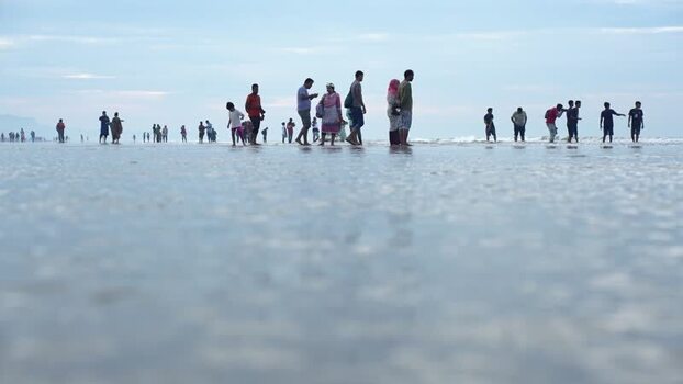 View of people on the reflective Cox s Bazar beach Bangladesh. View of people on the reflective Cox s Bazar beach Bangladesh.