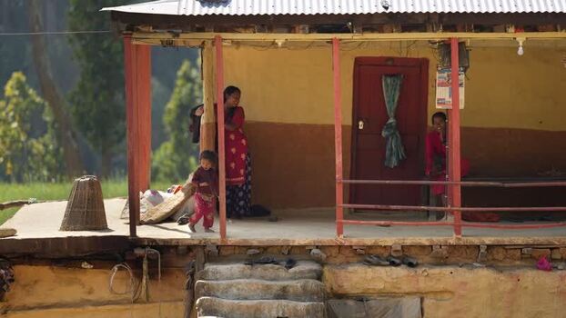 View of women and a child on a traditional house porch Nepal. View of women and a child on a traditional house porch Nepal.