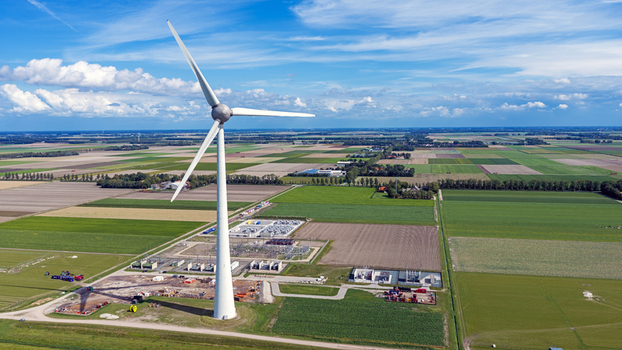Aerial view of a large wind turbine with an electric substation in Espel Flevoland Netherlands Aerial view of a large wind turbine with an electric substation in Espel Flevoland Netherlands