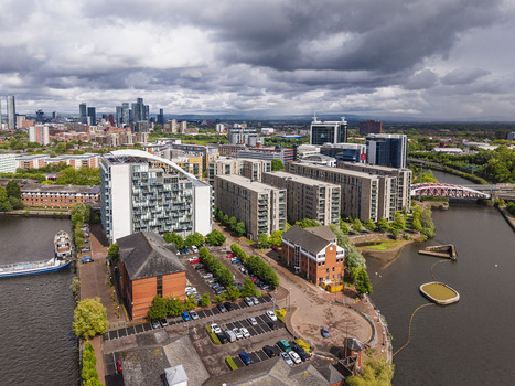 Aerial view of MediaCityUK with modern apartment buildings parking lots and the Manchester Ship Canal in Salford England United Kingdom. Aerial view of MediaCityUK with modern apartment buildings parking lots and the Manchester Ship Canal in Salford England United Kingdom.