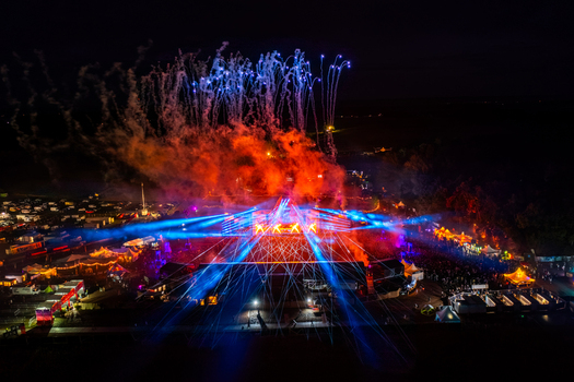 Herzogenaurach Germany 24 July 2025 Aerial view of Open Beatz Festival featuring fireworks blue laser lights and a large illuminated stage at night.