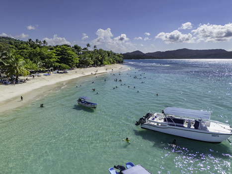 Aerial view of Javo Beach La Playita with turquoise water white sand boats and people swimming in Las Galeras Las Galeras Dominican Republic. Aerial view of Javo Beach La Playita with turquoise water white sand boats and people swimming in Las Galeras Las Galeras Dominican Republic.