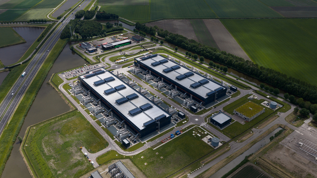 Aerial view of the Agriport data center complex with its large industrial buildings and cooling systems surrounded by green fields in Middenmeer Noord Holland Netherlands. Aerial view of the Agriport data center complex with its large industrial buildings and cooling systems surrounded by green fields in Middenmeer Noord Holland Netherlands.