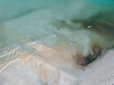 Aerial view of the serene shoreline where turquoise waters meet the pristine sands of Pantai Tanjung Aan West Nusa Tenggara Indonesia. Aerial view of the serene shoreline where turquoise waters meet the pristine sands of Pantai Tanjung Aan West Nusa Tenggara Indonesia.