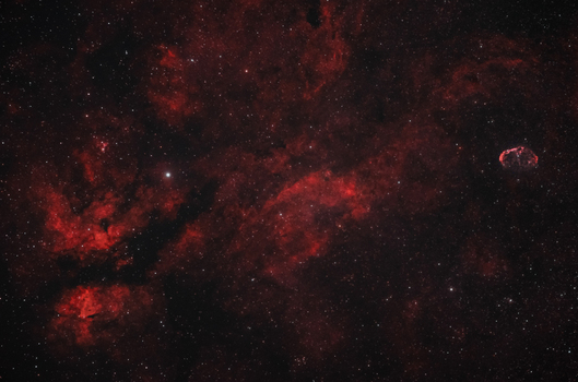 View of the Butterfly Nebula in the constellation Cygnus showcasing vibrant red ionized hydrogen gas clouds and dense star fields in Poland. View of the Butterfly Nebula in the constellation Cygnus showcasing vibrant red ionized hydrogen gas clouds and dense star fields in Poland.