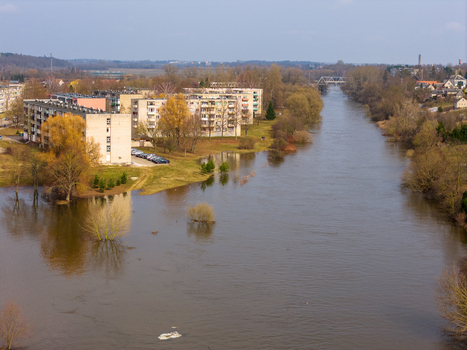 Kedainiai Lithuania 17 March 2026 Aerial view of the flooded Nevezis river flowing past residential apartment blocks and leafless trees during the spring thaw. Kedainiai Lithuania 17 March 2026 Aerial view of the flooded Nevezis river flowing past residential apartment blocks and leafless trees during the spring thaw.